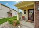 Front porch with small seating area, front door with decor, and manicured landscaping at 5361 Cradle River Ct, Indianapolis, IN 46221