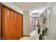 Hallway features neutral paint, a window, and an orange double door closet at 5361 Cradle River Ct, Indianapolis, IN 46221