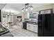 Modern kitchen boasts white cabinets, black appliances, and a cozy breakfast nook, perfect for casual dining at 5361 Cradle River Ct, Indianapolis, IN 46221