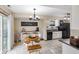 Eat-in kitchen with black appliances and white cabinets, complemented by a stylish dining area and natural light at 5361 Cradle River Ct, Indianapolis, IN 46221