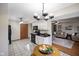 Open kitchen showcases white cabinets, modern appliances, and seamless flow into the inviting living room at 5361 Cradle River Ct, Indianapolis, IN 46221