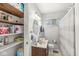Bathroom featuring a wooden vanity, oval mirror and linen storage at 5427 Heights Ave, Indianapolis, IN 46237