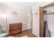 Bright bedroom featuring a rustic wooden dresser and ample storage in the closet at 5427 Heights Ave, Indianapolis, IN 46237