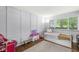 Bright bedroom featuring a daybed, hardwood floors, and playful decor at 5427 Heights Ave, Indianapolis, IN 46237