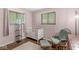 Cozy Bedroom with a white crib, comfortable rocking chair, and a soft, neutral rug at 5427 Heights Ave, Indianapolis, IN 46237