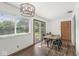Bright dining room with a modern light fixture, wood floors, and a sliding glass door to the backyard patio at 5427 Heights Ave, Indianapolis, IN 46237