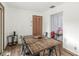 Charming dining area featuring wood floors, a rustic table, and a view into an adjacent play area at 5427 Heights Ave, Indianapolis, IN 46237