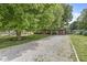 Traditional single Gathering home with a long gravel driveway and mature landscaping in a serene, wooded setting at 5427 Heights Ave, Indianapolis, IN 46237