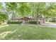 Charming brick ranch home featuring a well-manicured lawn and inviting curb appeal with a covered front entry at 5427 Heights Ave, Indianapolis, IN 46237