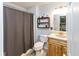 Well-maintained bathroom with a shower, a wooden vanity and a granite sink at 560 Old Farm Rd, Danville, IN 46122