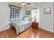 Cozy bedroom with hardwood floors, ceiling fan, and a bright window at 560 Old Farm Rd, Danville, IN 46122