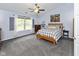 Cozy bedroom with a queen-size bed, gray carpet, and ample natural light at 560 Old Farm Rd, Danville, IN 46122