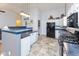 Well-lit kitchen features tile floors, white cabinets, and stainless steel appliances at 560 Old Farm Rd, Danville, IN 46122
