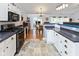Eat-in kitchen with tile floors, white cabinets, and stainless steel appliances at 560 Old Farm Rd, Danville, IN 46122