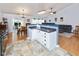 Modern kitchen with tile floors, white cabinets, and a view of the dining and living areas at 560 Old Farm Rd, Danville, IN 46122