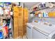 Functional laundry room with washer, dryer, and ample storage shelving at 560 Old Farm Rd, Danville, IN 46122