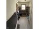 An under-construction bathroom shows a tiled accent wall and black and white flooring at 5960 Southeastern Ave, Indianapolis, IN 46203