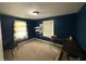 Bedroom in dark blue featuring an open closet and two windows at 5960 Southeastern Ave, Indianapolis, IN 46203