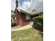 This brick home features steps and a walkway, with a classic chimney, offering a warm and inviting facade at 5960 Southeastern Ave, Indianapolis, IN 46203