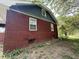Side of home with brick and siding and view of yard and vegetation at 5960 Southeastern Ave, Indianapolis, IN 46203
