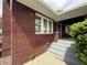 Classic brick home featuring a covered porch and white-framed windows at 5960 Southeastern Ave, Indianapolis, IN 46203