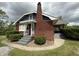 View of the red brick home with front steps and a classic chimney at 5960 Southeastern Ave, Indianapolis, IN 46203