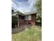 Charming brick home with a covered porch, complemented by lush greenery at 5960 Southeastern Ave, Indianapolis, IN 46203