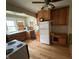 View of a kitchen featuring hardwood floors, a refrigerator, and wooden cabinets at 5960 Southeastern Ave, Indianapolis, IN 46203