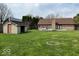 Large backyard with a shed, brick house, a deck, a hot tub, and plenty of green space at 6143 Roberts Pl, Indianapolis, IN 46220