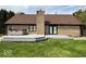 Home features a large backyard with deck, hot tub and brick exterior at 6143 Roberts Pl, Indianapolis, IN 46220