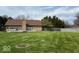 Spacious backyard with green grass, privacy fence and a brick exterior at 6143 Roberts Pl, Indianapolis, IN 46220