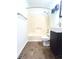 Bathroom features a tub with shower, toilet, and a vanity with storage at 6143 Roberts Pl, Indianapolis, IN 46220