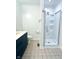 Updated bathroom includes a large shower with glass door, modern vanity and tiled floors at 6143 Roberts Pl, Indianapolis, IN 46220