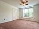 Bedroom includes neutral walls, carpet, a closet and large window letting in natural light at 6143 Roberts Pl, Indianapolis, IN 46220