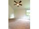 Spacious bedroom includes a ceiling fan, plush carpet and a large window to view the outdoors at 6143 Roberts Pl, Indianapolis, IN 46220