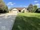 Inviting single-Gathering home featuring a well-manicured lawn, mature trees, and a long driveway at 6143 Roberts Pl, Indianapolis, IN 46220