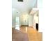 Bright foyer featuring hardwood floors, high ceilings, and an open layout flowing into other rooms at 6143 Roberts Pl, Indianapolis, IN 46220