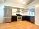 Modern kitchen with stainless steel appliances, sleek cabinetry, and hardwood floors at 6143 Roberts Pl, Indianapolis, IN 46220