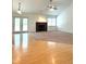Spacious living room with hardwood floors, a cozy fireplace, and natural light from windows and doors at 6143 Roberts Pl, Indianapolis, IN 46220