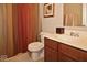 Bathroom features single sink vanity, toilet, and shower with patterned curtain at 6304 El Paso St, Whitestown, IN 46075