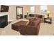 Sun-lit living room with neutral decor, fireplace, and comfortable seating at 6304 El Paso St, Whitestown, IN 46075