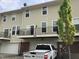 Rear exterior featuring balconies and garage access to townhome at 6304 El Paso St, Whitestown, IN 46075