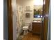 Bathroom featuring a toilet, vanity with sink, and shower with a curtain at 6723 S New Jersey St, Indianapolis, IN 46227