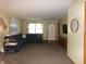 Open living room with a plush sofa, large window, and neutral color palette at 6723 S New Jersey St, Indianapolis, IN 46227