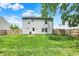 This backyard features a wooden privacy fence, a grassy lawn and is very well maintained at 6809 Amber Springs Way, Indianapolis, IN 46237