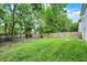 Large backyard features a wooden privacy fence, a grassy lawn and a storage shed at 6809 Amber Springs Way, Indianapolis, IN 46237