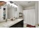 Bright bathroom featuring double sinks, dark vanity and a shower with a shower curtain at 6809 Amber Springs Way, Indianapolis, IN 46237