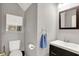 Bathroom with a toilet, sink, mirror, towel and built-in cabinet at 6809 Amber Springs Way, Indianapolis, IN 46237