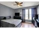 Comfortable bedroom with window, carpet flooring, ceiling fan, and large dresser offers ample storage at 6809 Amber Springs Way, Indianapolis, IN 46237