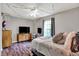 Comfortable bedroom with a large window for natural light, stylish furnishings, and wood-look flooring at 6809 Amber Springs Way, Indianapolis, IN 46237